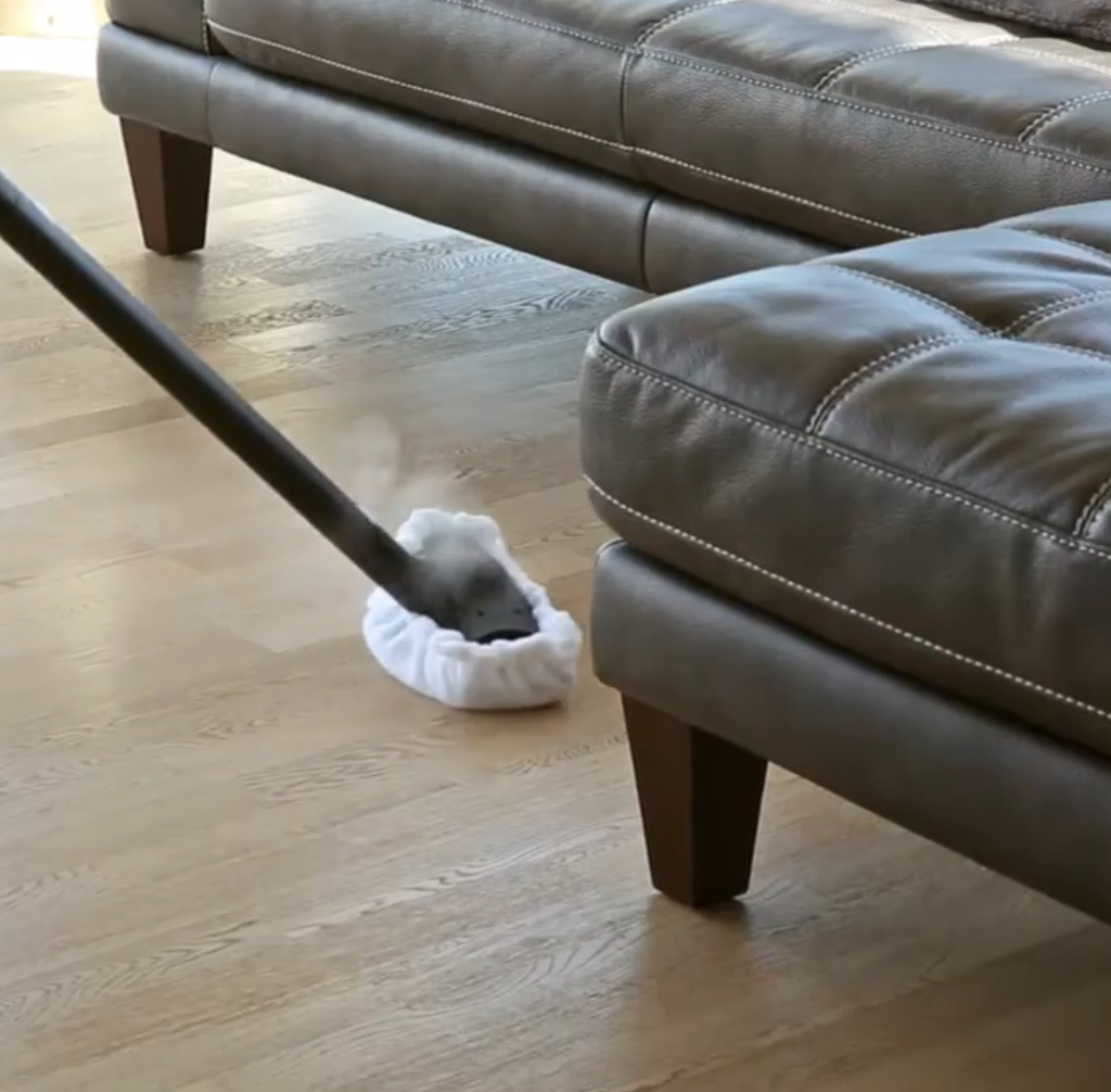 Cleaning a hardwood floor with steam vacuum cleaner