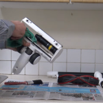 A person cleaning cordless vacuum cleaner