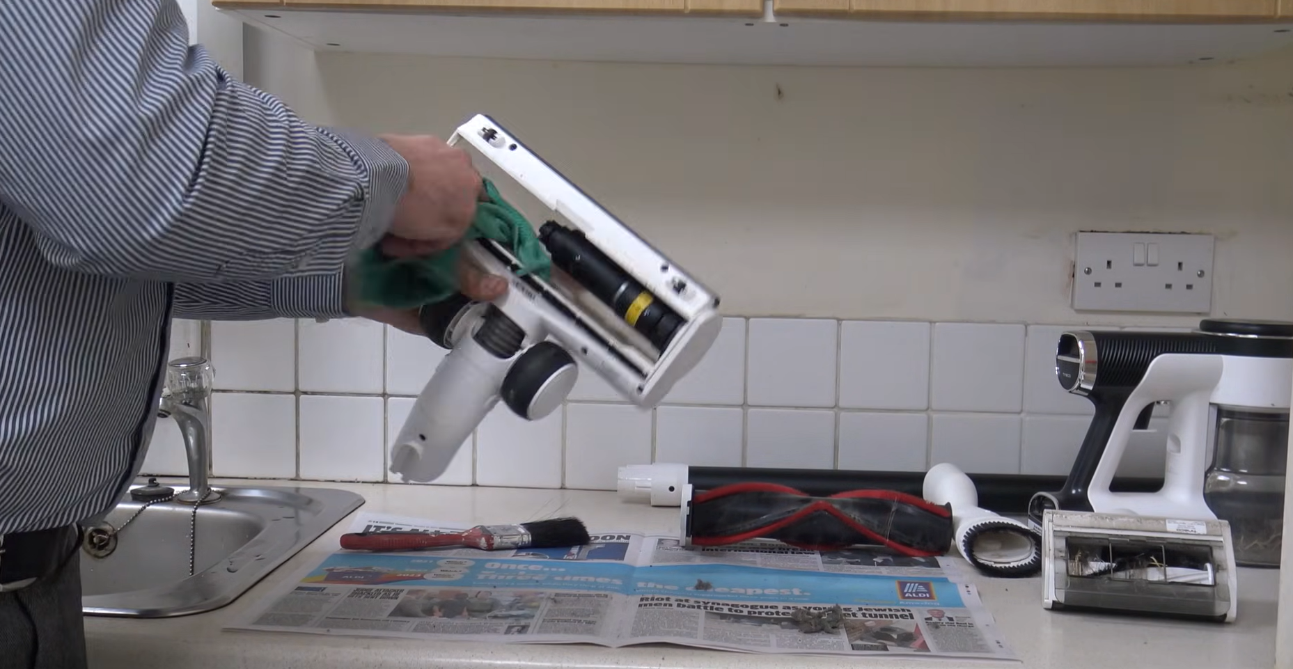 A person cleaning cordless vacuum cleaner