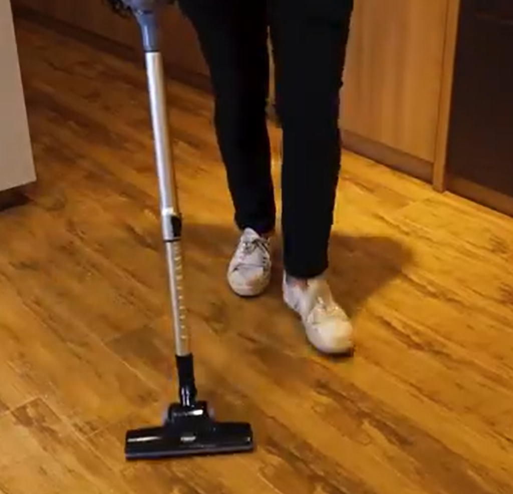 A person using a handheld vacuum cleaner