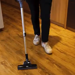 A person using a handheld vacuum cleaner