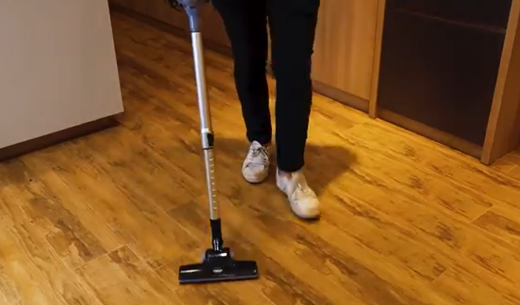 A person using a handheld vacuum cleaner